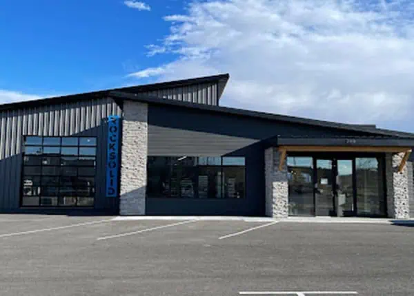 Modern commercial steel building with stone accents and glazed entry