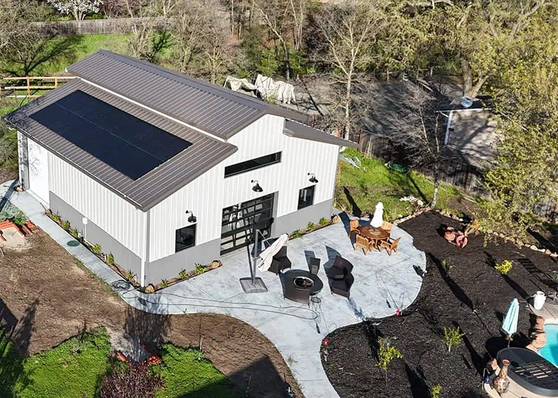 Aerial view of residential steel barndominium with solar panels