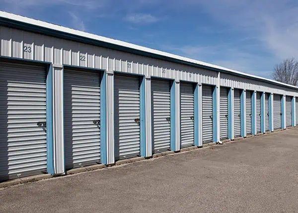 Row of steel self-storage units with roll-up doors