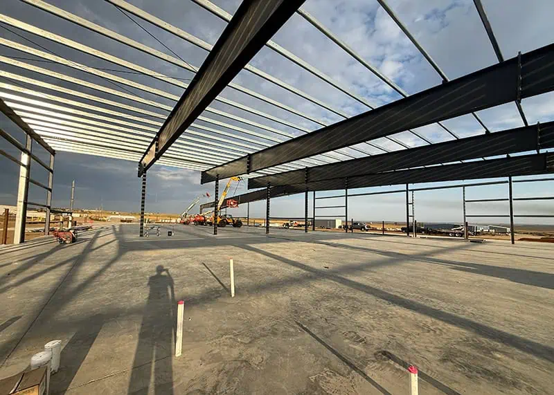 Steel frame structure under construction at sunset